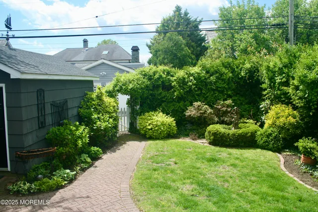 a view of a pathway of a house with a tree