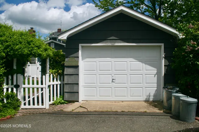 a view of a house with brick walls and a yard with plants