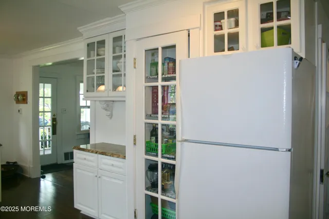 a kitchen with a refrigerator and a window