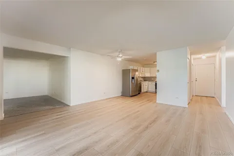 a view of empty room with wooden floor