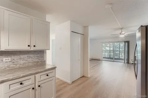 a view of a kitchen with wooden floor and electronic appliances