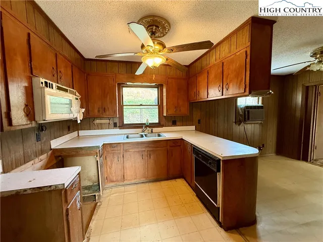 a kitchen with a stove a sink and a microwave