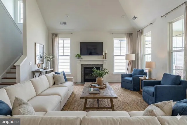 a living room with furniture fireplace and window