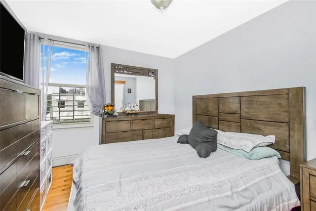 a bedroom with a bed and large mirror