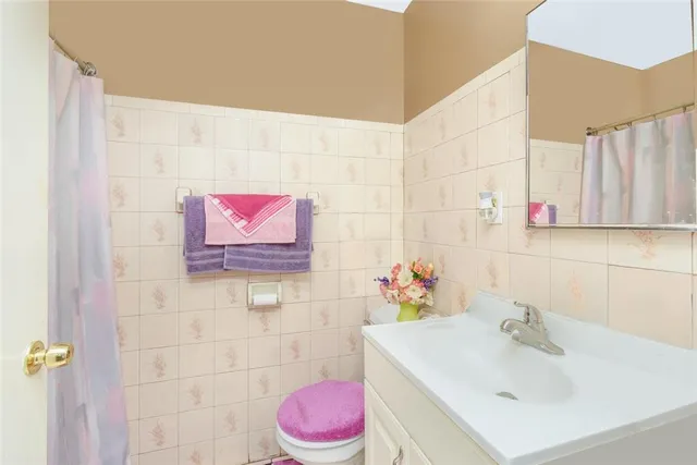 a bathroom with a sink mirror and vanity