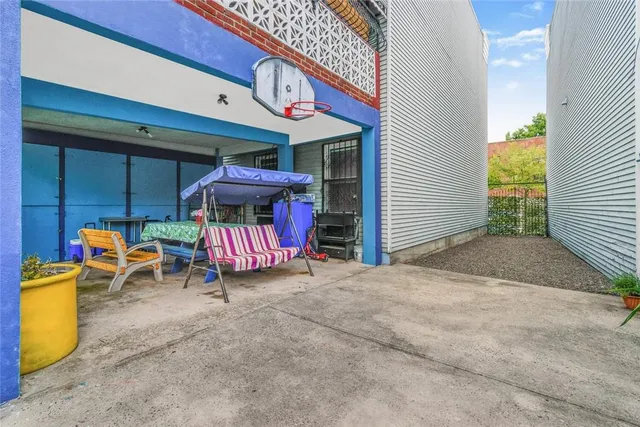 a view of a patio with table and chairs under an umbrella
