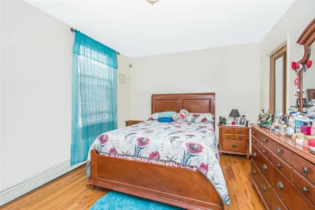 a bedroom with a bed and a dresser