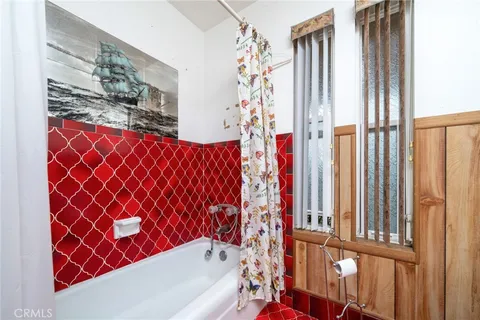 a bathroom with a bathtub and shower