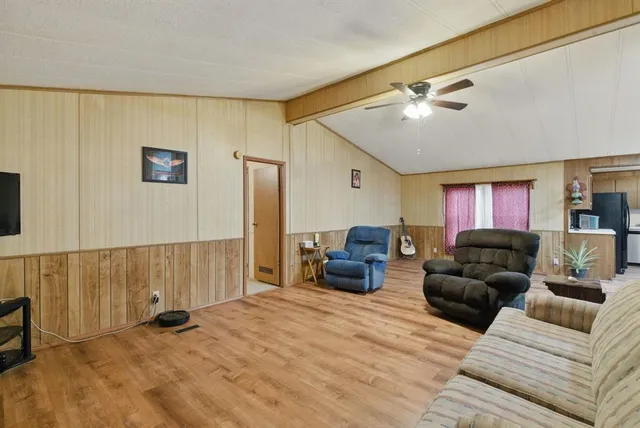 a view of a workspace with furniture and wooden floor