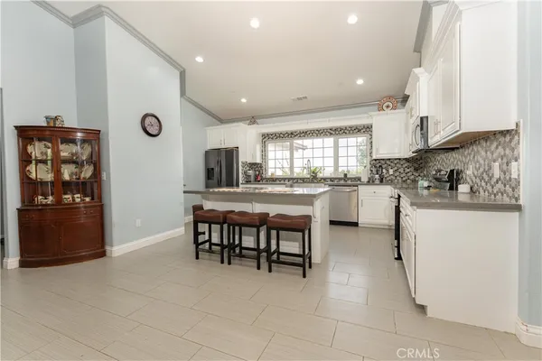a living room with furniture ceiling fan and a rug