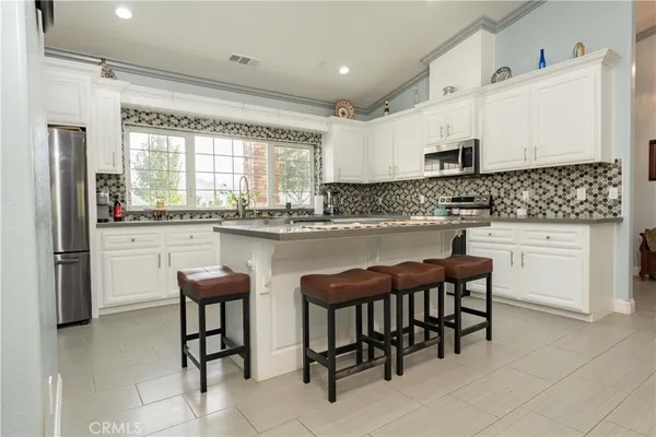 a kitchen with appliances cabinets and a large window