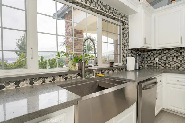 a kitchen with white cabinets and white appliances