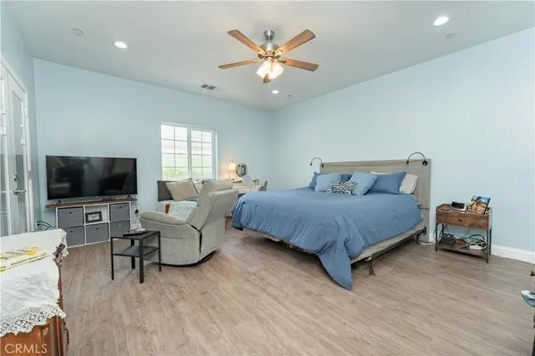 a bedroom with a bed and a chandelier