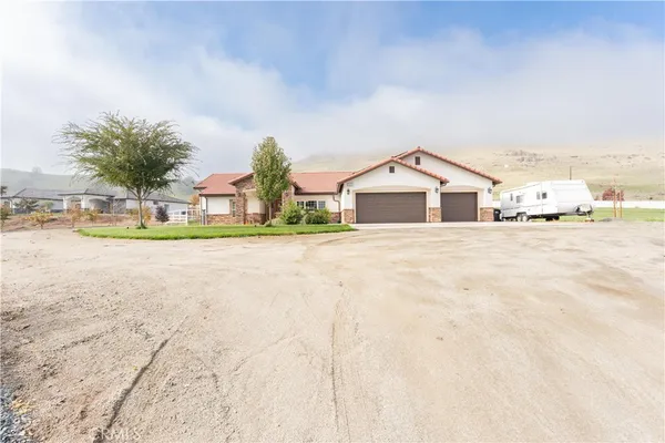 a view of a house with a swimming pool and sitting area
