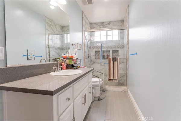 a spacious bathroom with a tub and balcony view