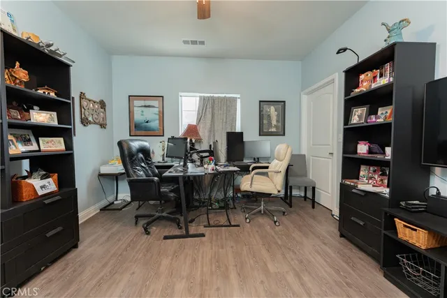 a big white house with a yard and wooden fence