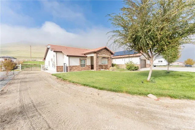 a view of house with a garden and pathway