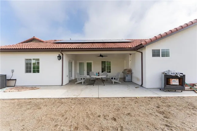 an aerial view of a house with a yard and lake view