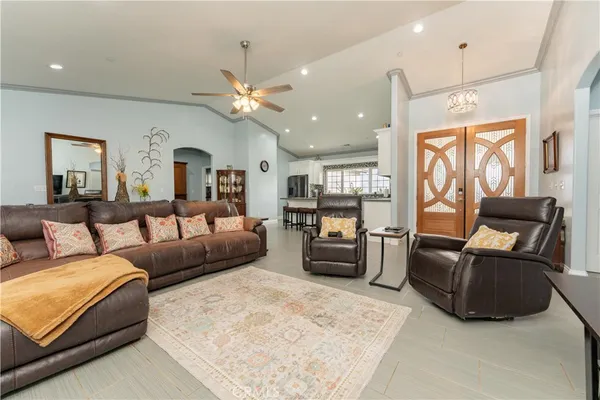 a living room with furniture and a chandelier