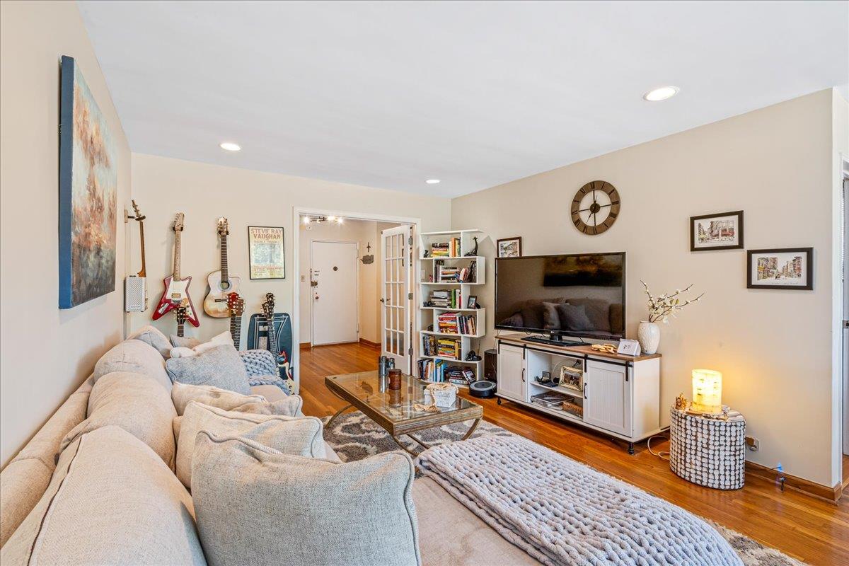 211-10 18th Avenue, Unit 2J Queens, NY 11360 - Photo 16 of 24 a living room with furniture and a flat screen tv