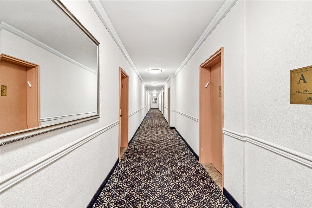211-10 18th Avenue, Unit 2J Queens, NY 11360 - Photo 4 of 24 a view of a hallway with wooden floor and staircase