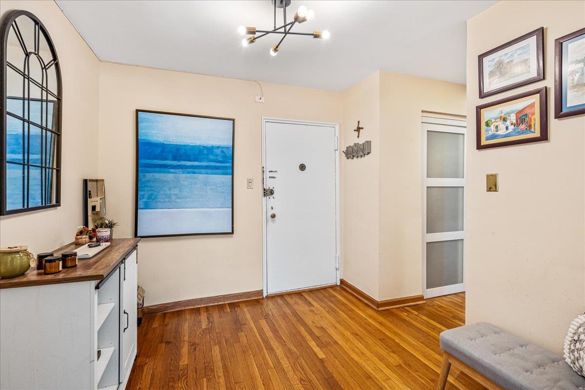 211-10 18th Avenue, Unit 2J Queens, NY 11360 - Photo 6 of 24 a view of an empty room with window and wooden floor