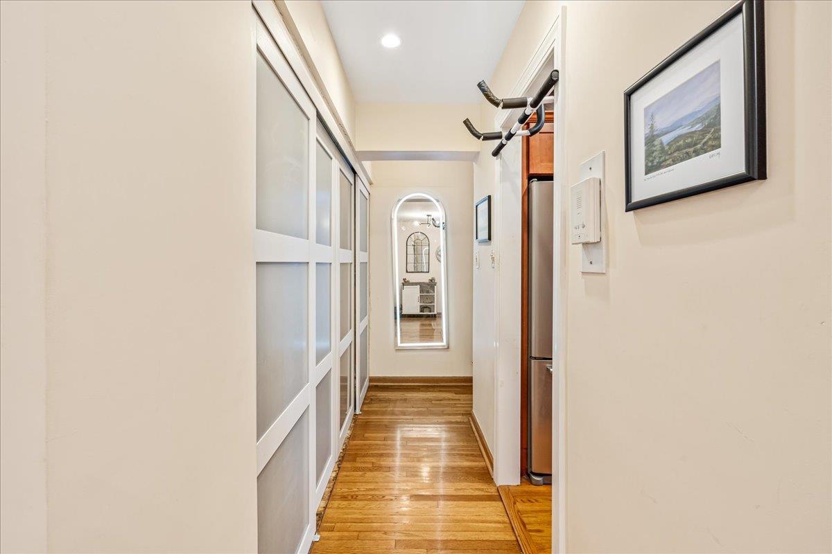 211-10 18th Avenue, Unit 2J Queens, NY 11360 - Photo 7 of 24 a view of a hallway with wooden floor and staircase