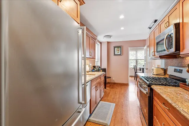 a kitchen with stainless steel appliances granite countertop a stove and a refrigerator