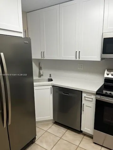a kitchen with a stove and a microwave