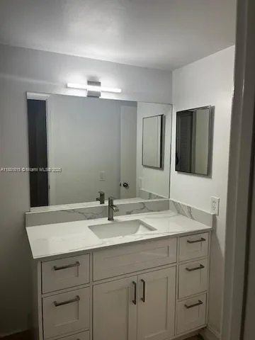 a view of a small space with wooden floor and a window