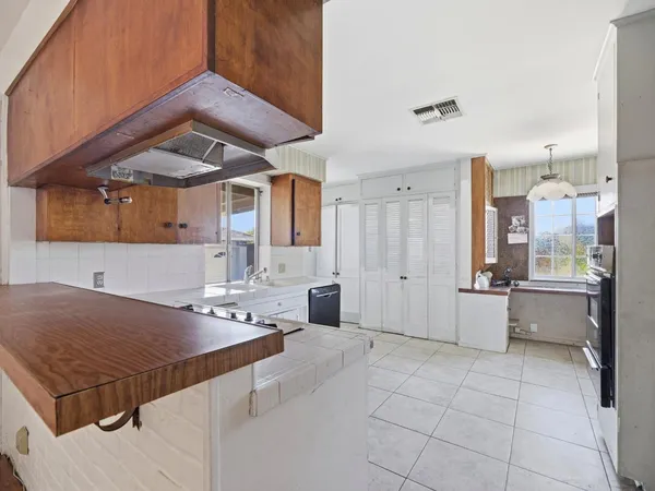 a view of a house with backyard sitting area and garden