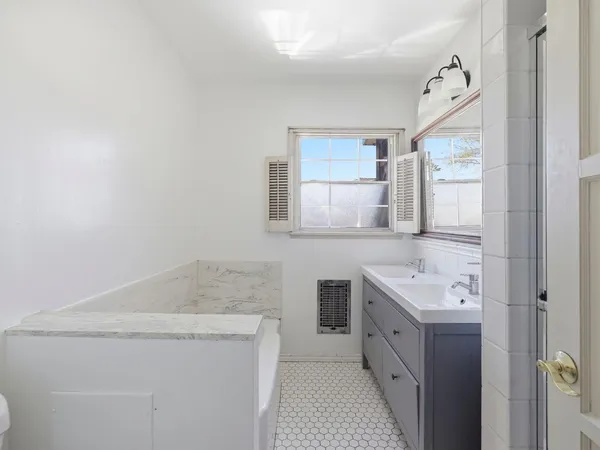 a front view of house with yard and trees in the background