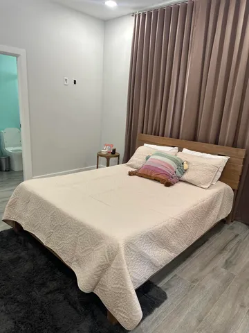 a bedroom with a bed and curtain