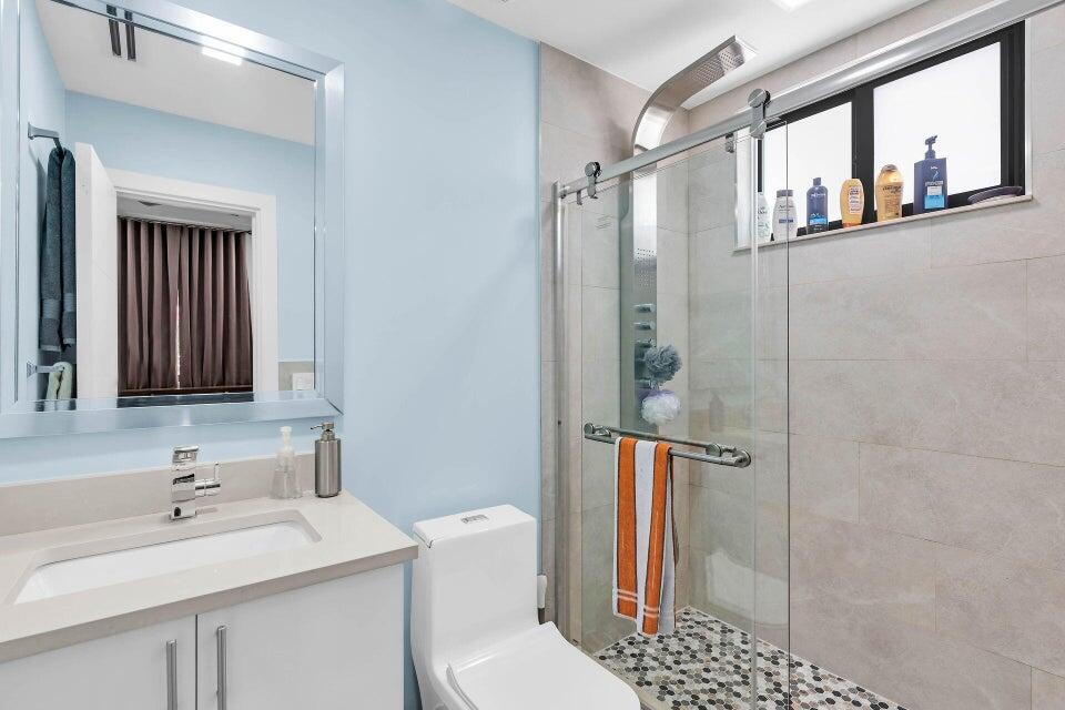 32 Atlantic Drive, Unit 32 Key Largo, FL 33037 - Photo 4 of 5 a bathroom with a sink toilet and shower