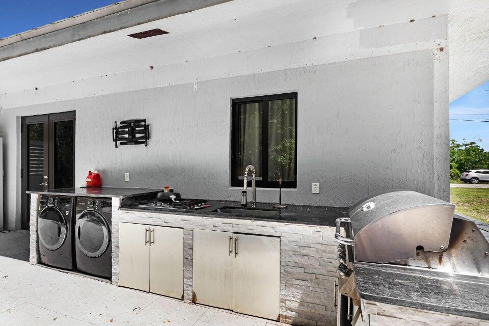 32 Atlantic Drive, Unit 32 Key Largo, FL 33037 - Photo 5 of 5 a kitchen with sink a stove and cabinets