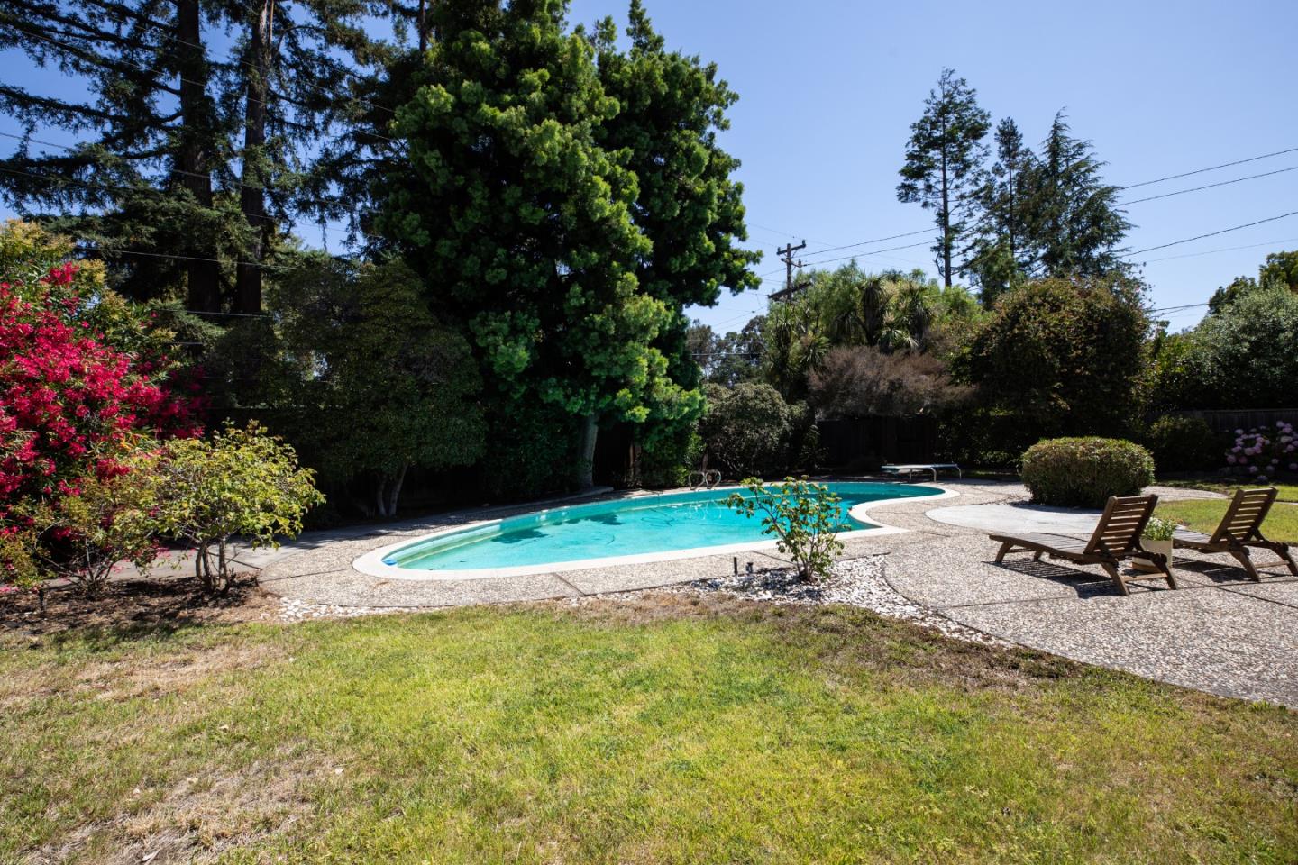 1208 Fairbrook Drive Mountain View, CA 94040 - Photo 4 of 5 a backyard of a house with table and chairs under an umbrella