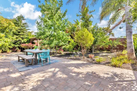 a view of a house with backyard porch and sitting area