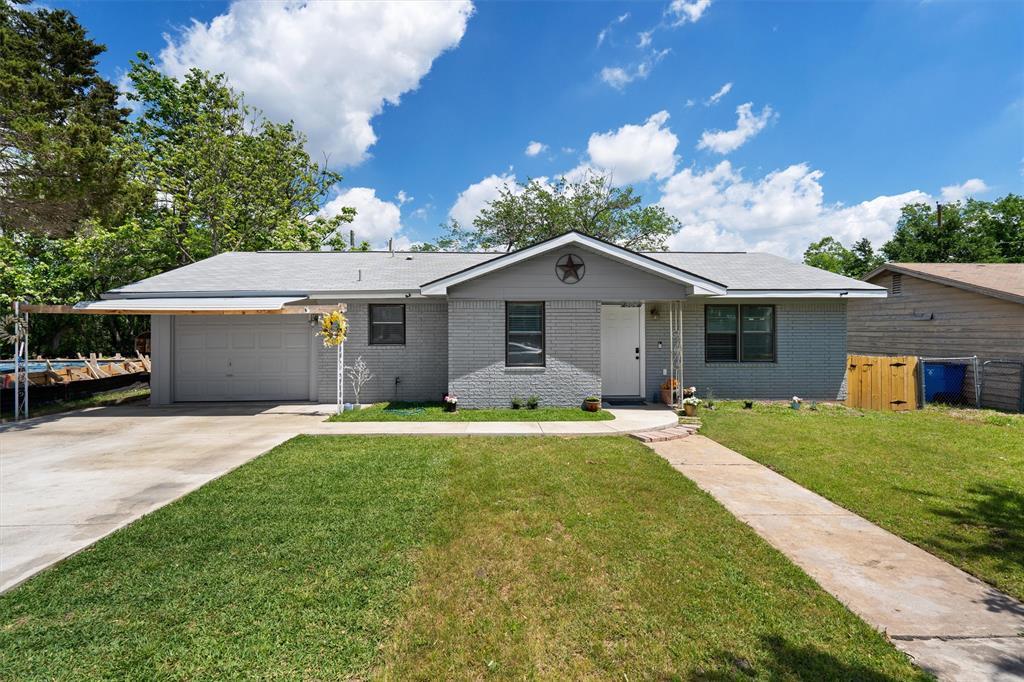 504 Debus Drive Taylor, TX 76574 - Photo 1 of 1 a front view of a house with a garden and yard