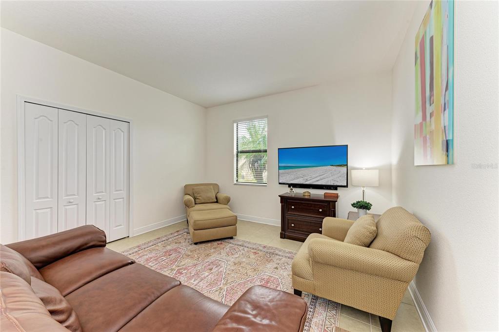 302 Cockle Shell Loop Apollo Beach, FL 33572 - Photo 47 of 75 a living room with furniture and a flat screen tv