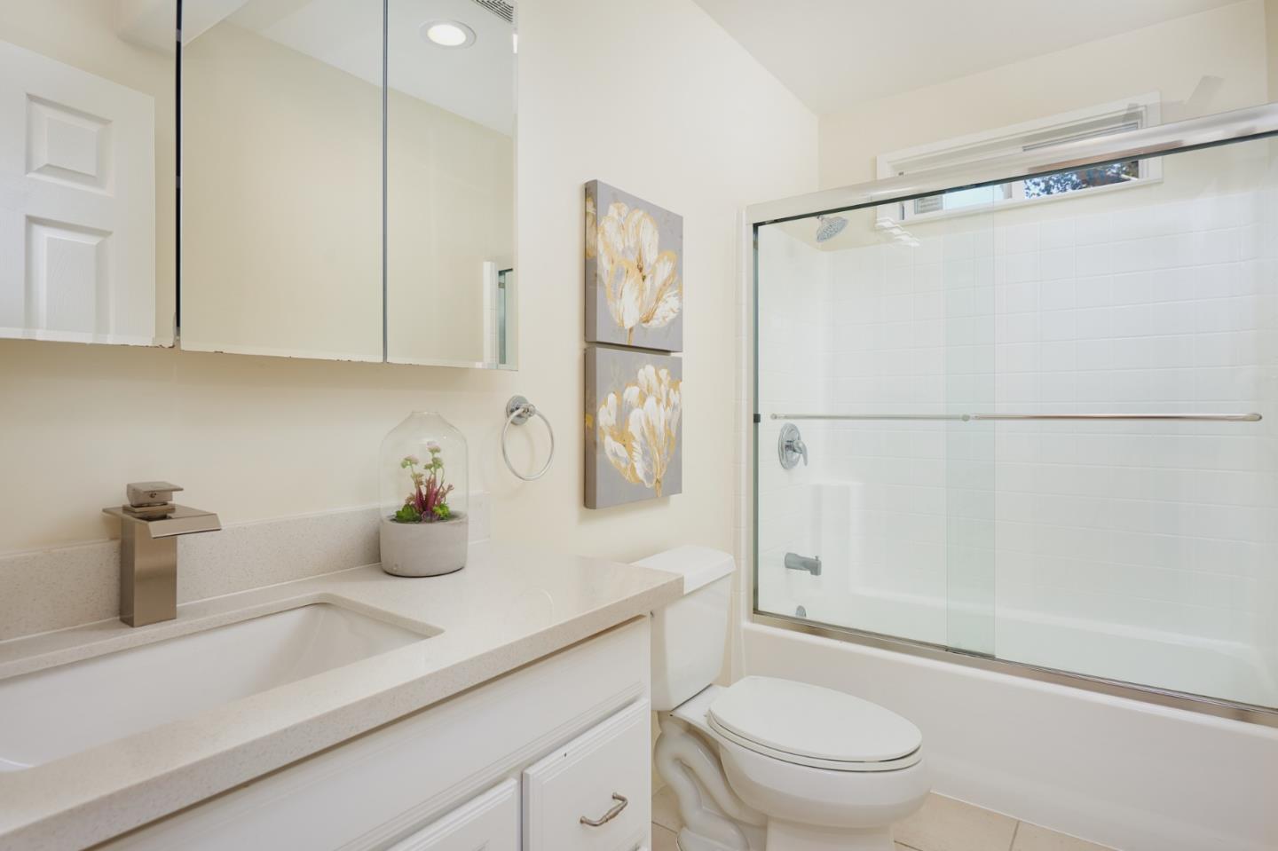1132 Lassen Drive Belmont, CA 94002 - Photo 23 of 27 a bathroom with a granite countertop sink a toilet and shower