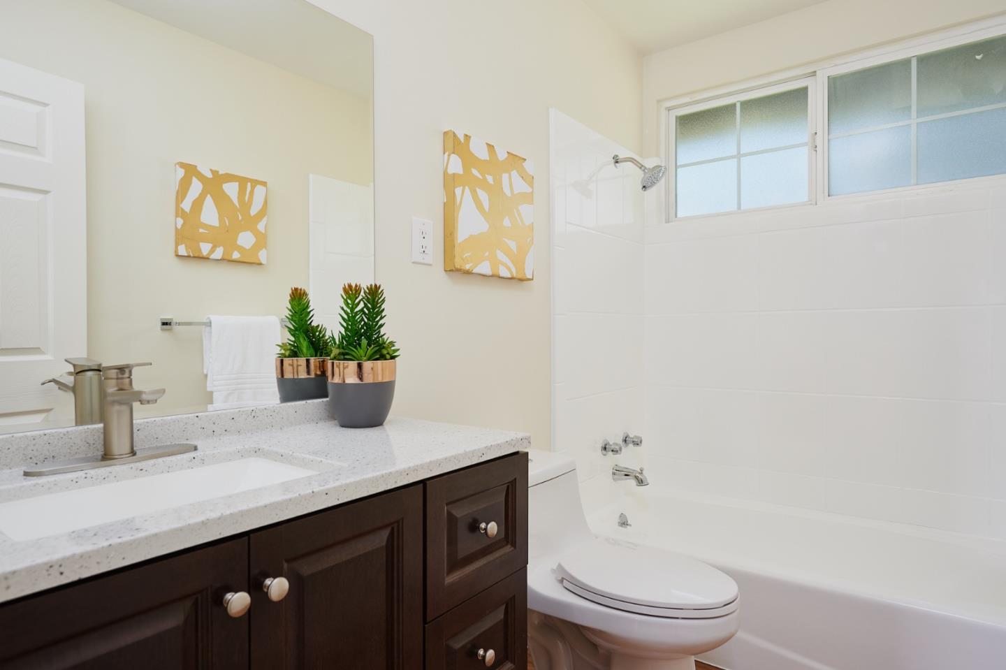 1132 Lassen Drive Belmont, CA 94002 - Photo 24 of 27 a bathroom with a granite countertop sink toilet and shower