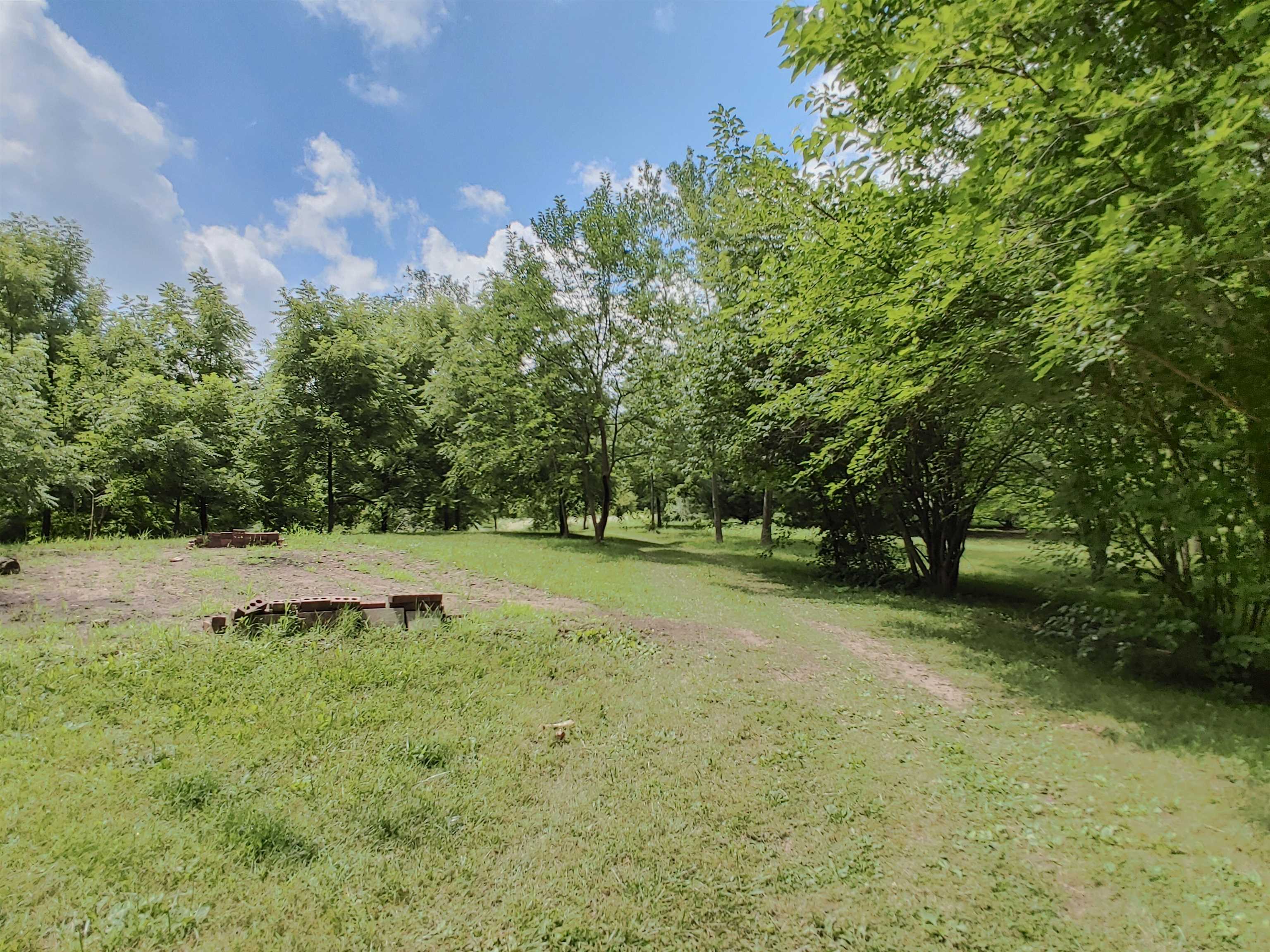 5152 Blackhawk Road Rockford, IL 61109 - Photo 13 of 31 a backyard of a house with trees and grass