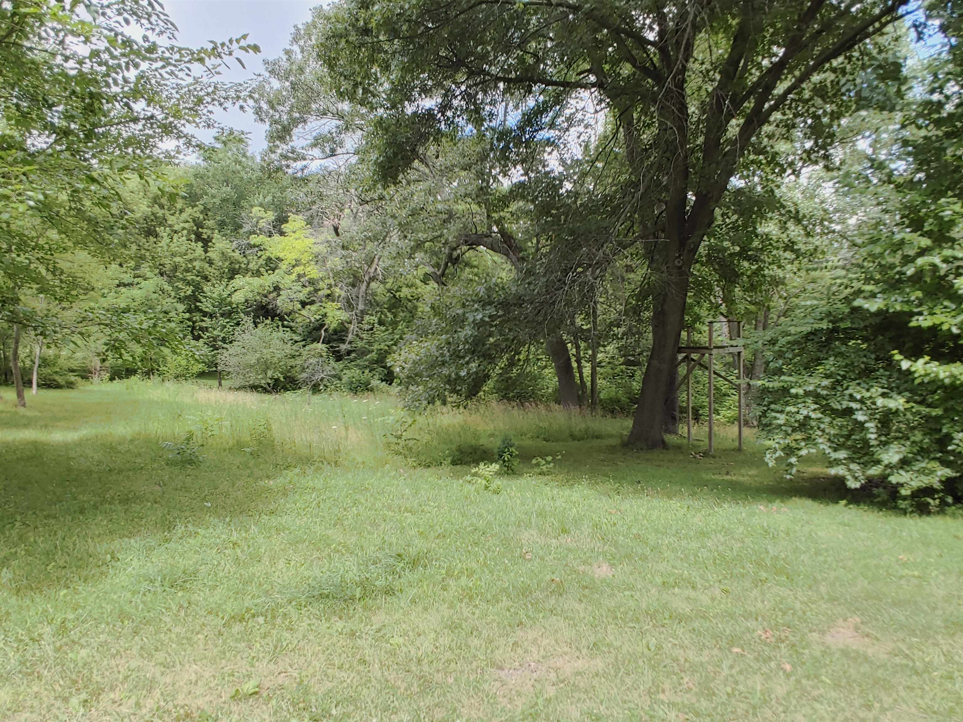 5152 Blackhawk Road Rockford, IL 61109 - Photo 18 of 31 a view of a green field with a tree