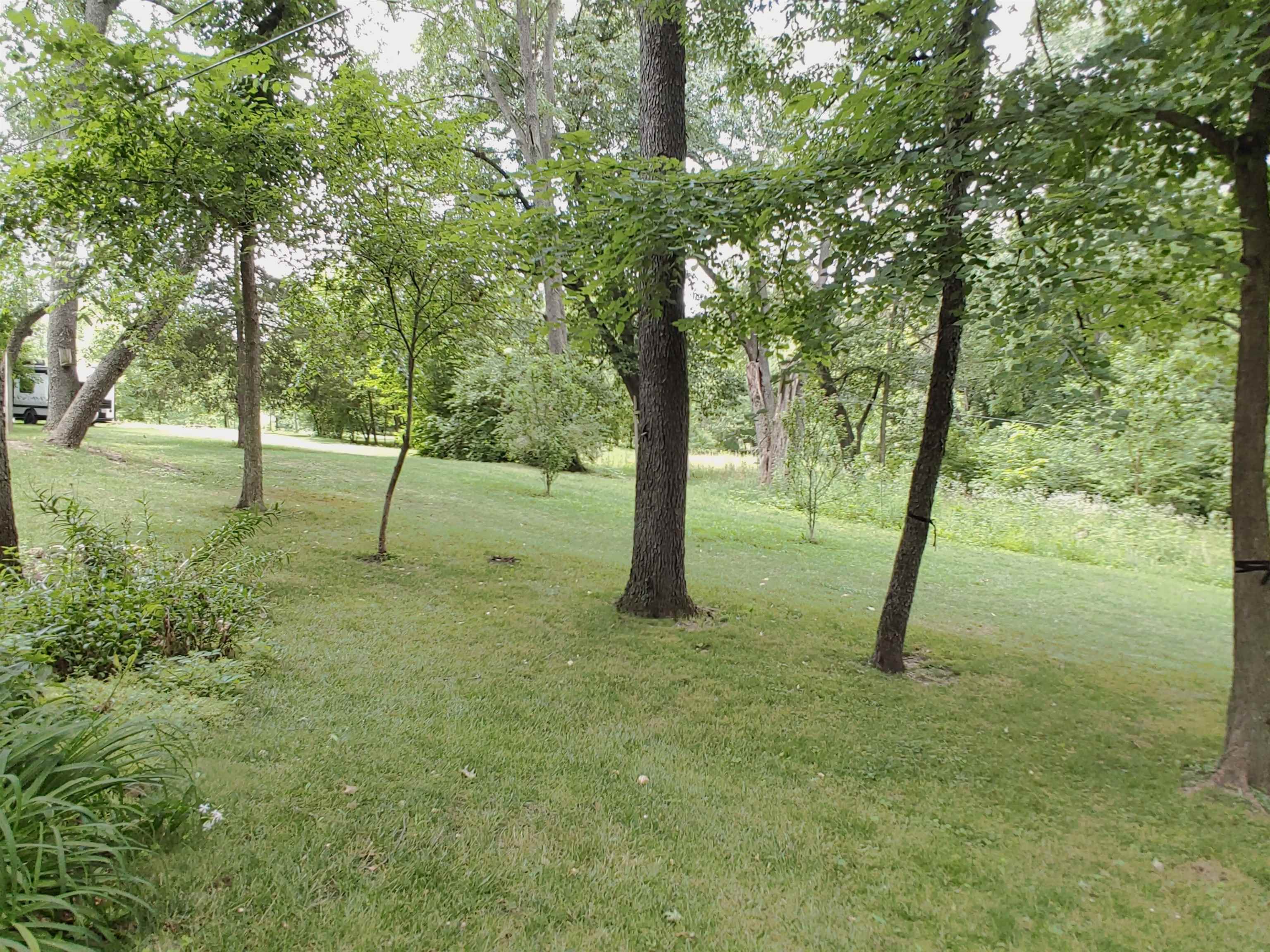 5152 Blackhawk Road Rockford, IL 61109 - Photo 20 of 31 a backyard of a house with lots of green space