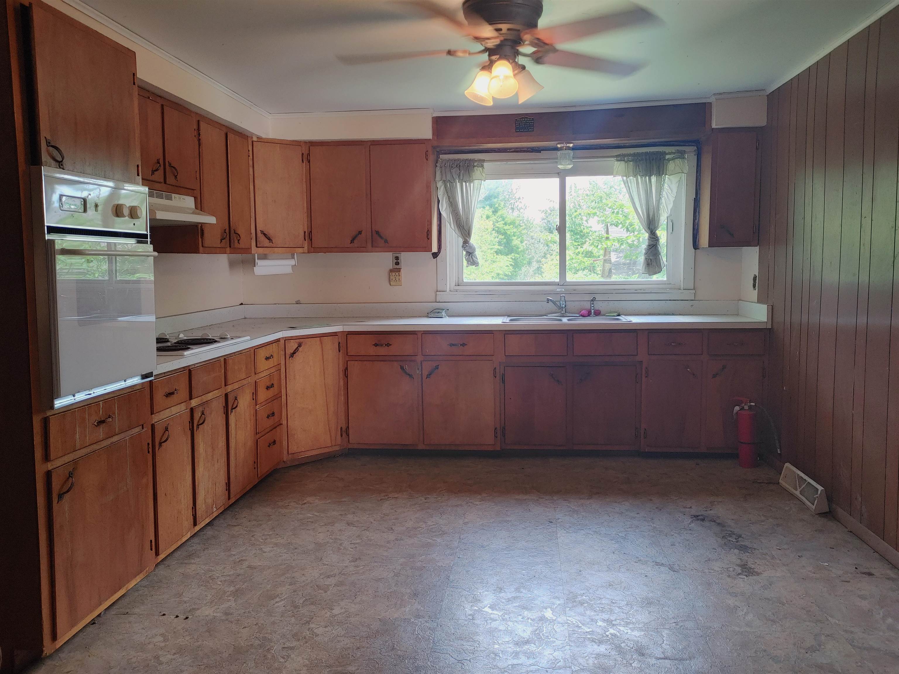 5152 Blackhawk Road Rockford, IL 61109 - Photo 23 of 31 a kitchen with stainless steel appliances granite countertop a stove a sink and a refrigerator with wooden cabinets