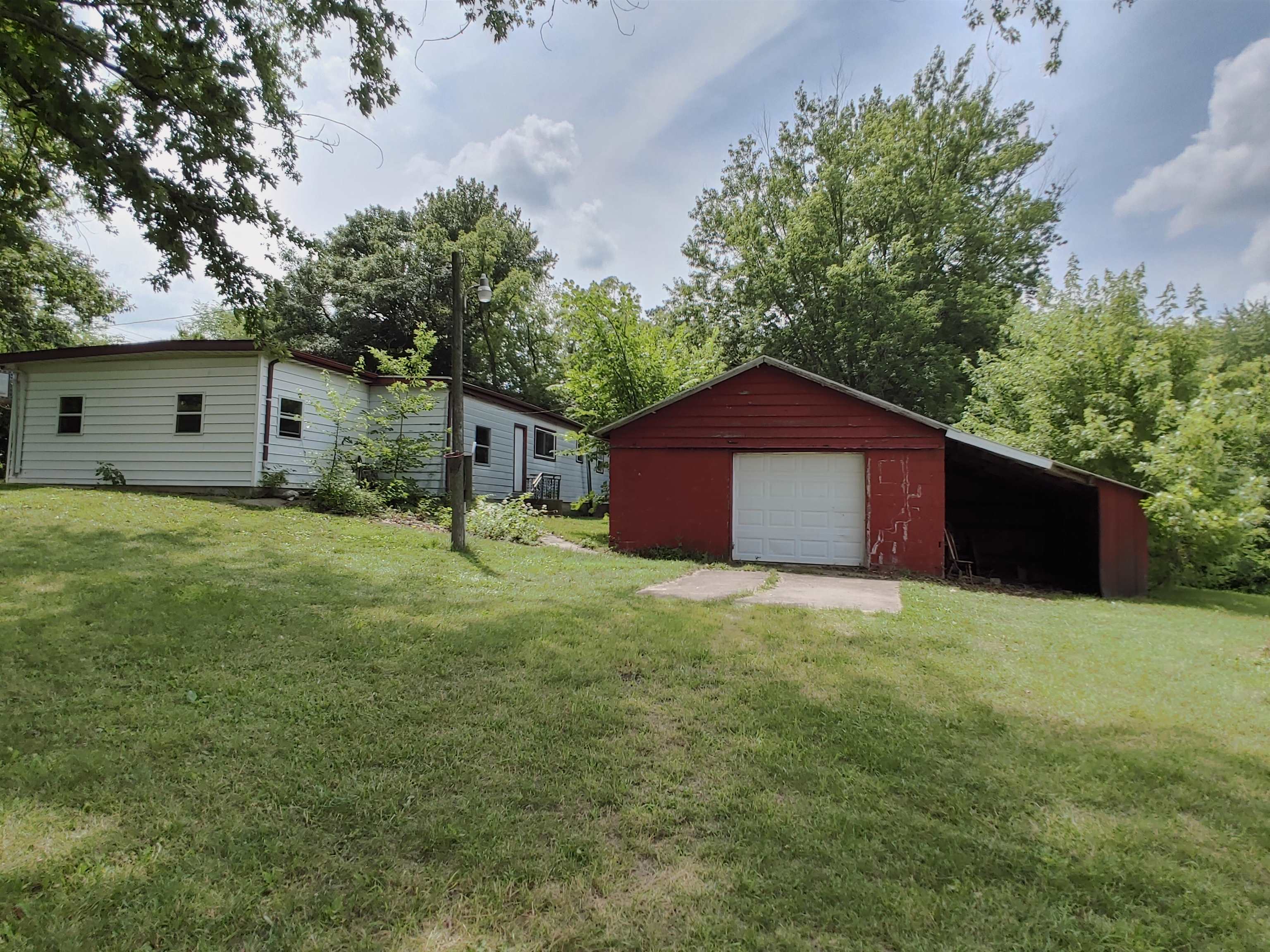 5152 Blackhawk Road Rockford, IL 61109 - Photo 5 of 31 a house is sitting in middle of the green field