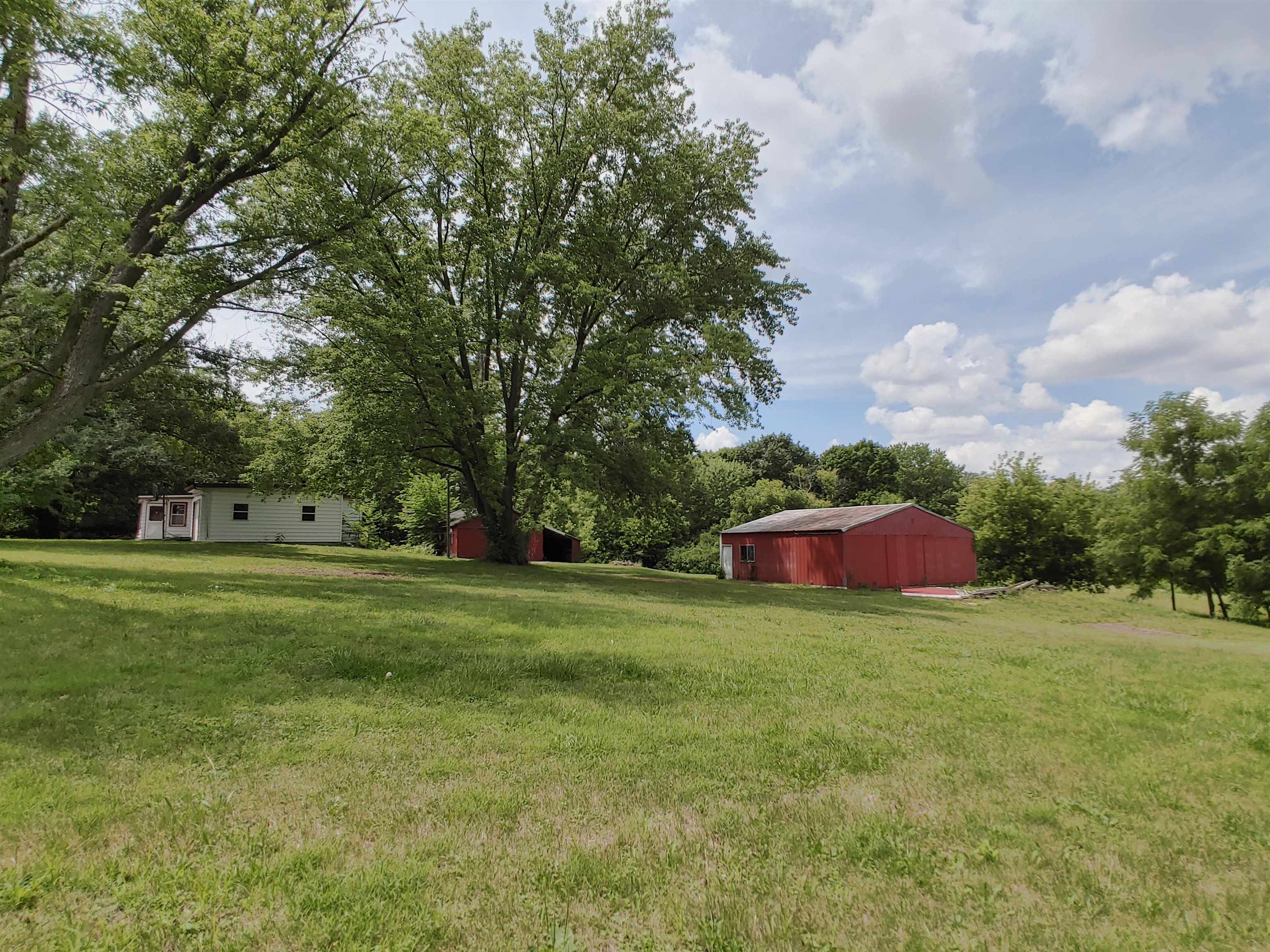 5152 Blackhawk Road Rockford, IL 61109 - Photo 9 of 31 a view of a field of grass and trees