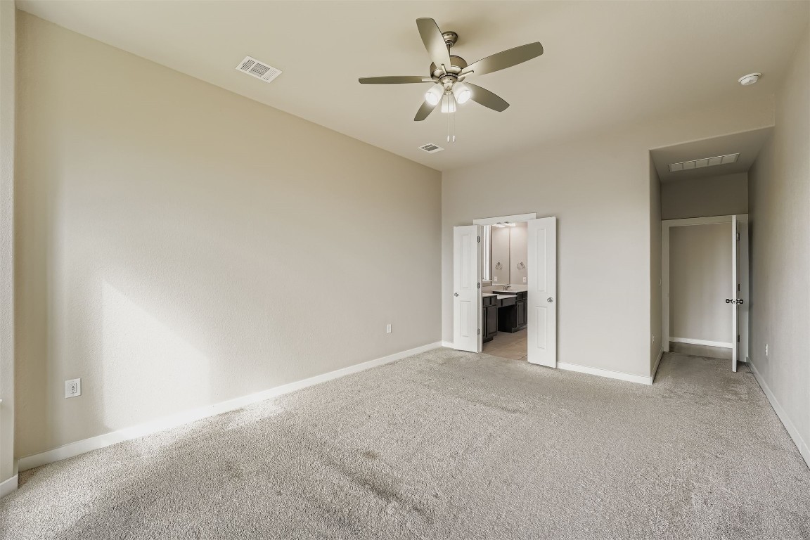 11209 American Mustang Loop Manor, TX 78653 - Photo 17 of 34 a view of an empty room with a ceiling fan