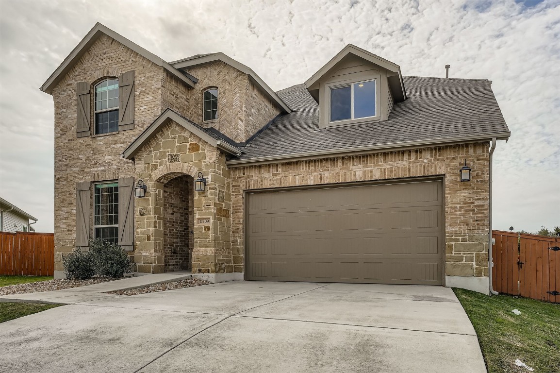 11209 American Mustang Loop Manor, TX 78653 - Photo 2 of 34 a front view of a house with garage