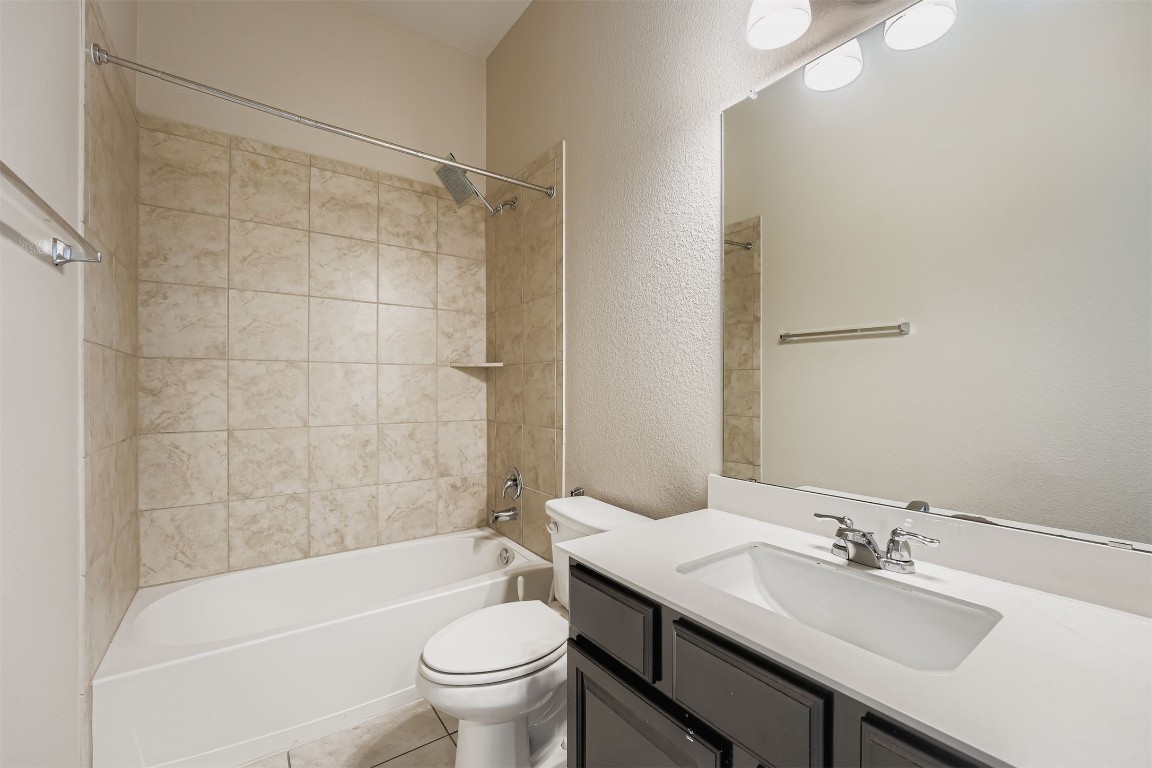 11209 American Mustang Loop Manor, TX 78653 - Photo 21 of 34 a bathroom with a sink a toilet and a bathtub